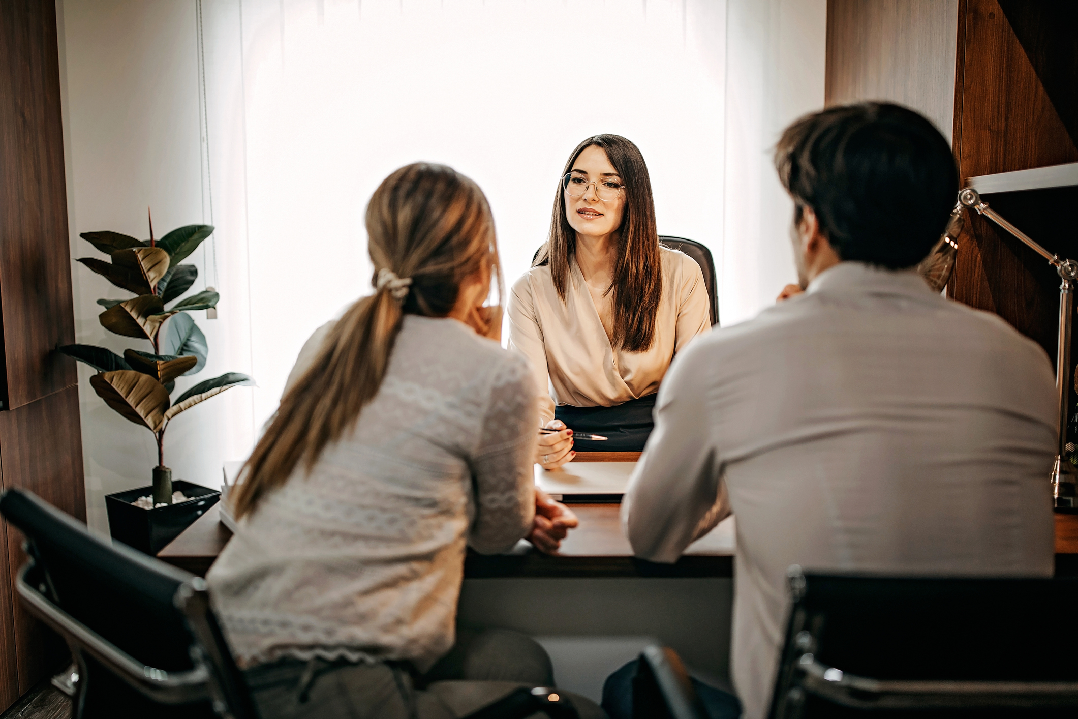 Attorney consulting with clients across a conference table